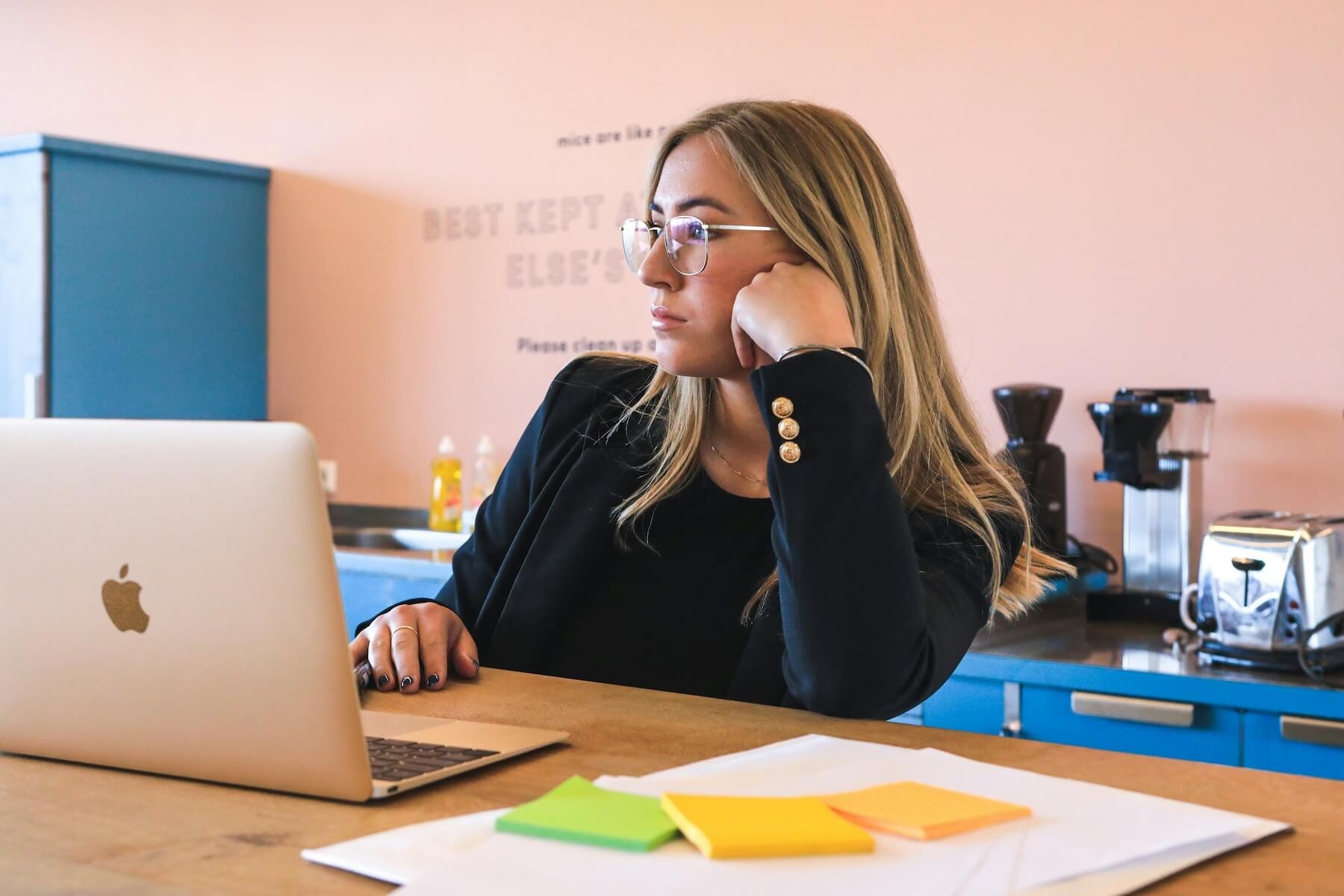 Developer sitting at a laptop pondering which jobs to apply for