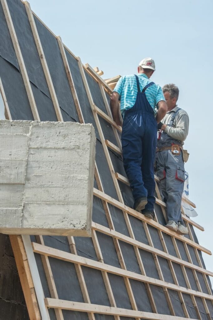 Construction workers framing a roof on a condo building