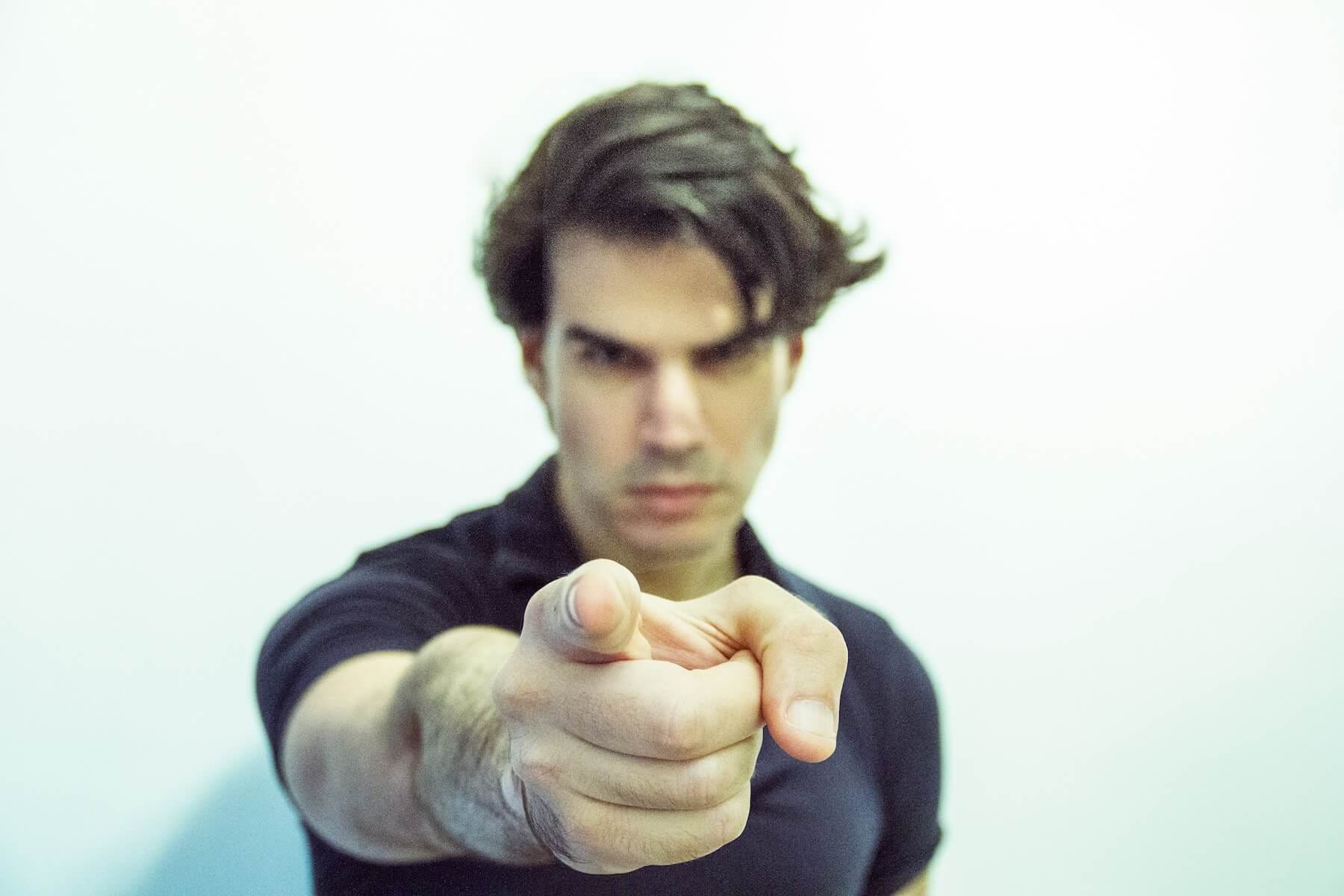 Man pointing directly at the viewer, asking for your opinion