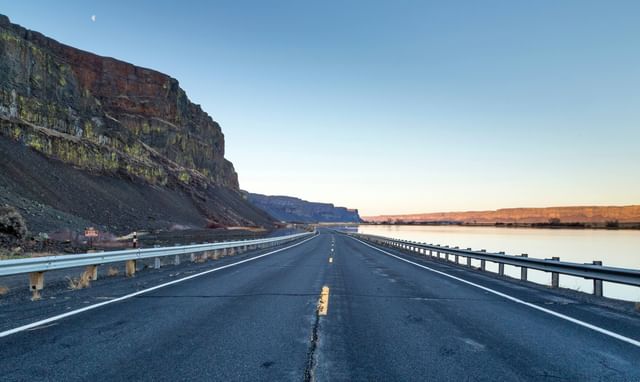 photo of an open road with guardrails on the side
